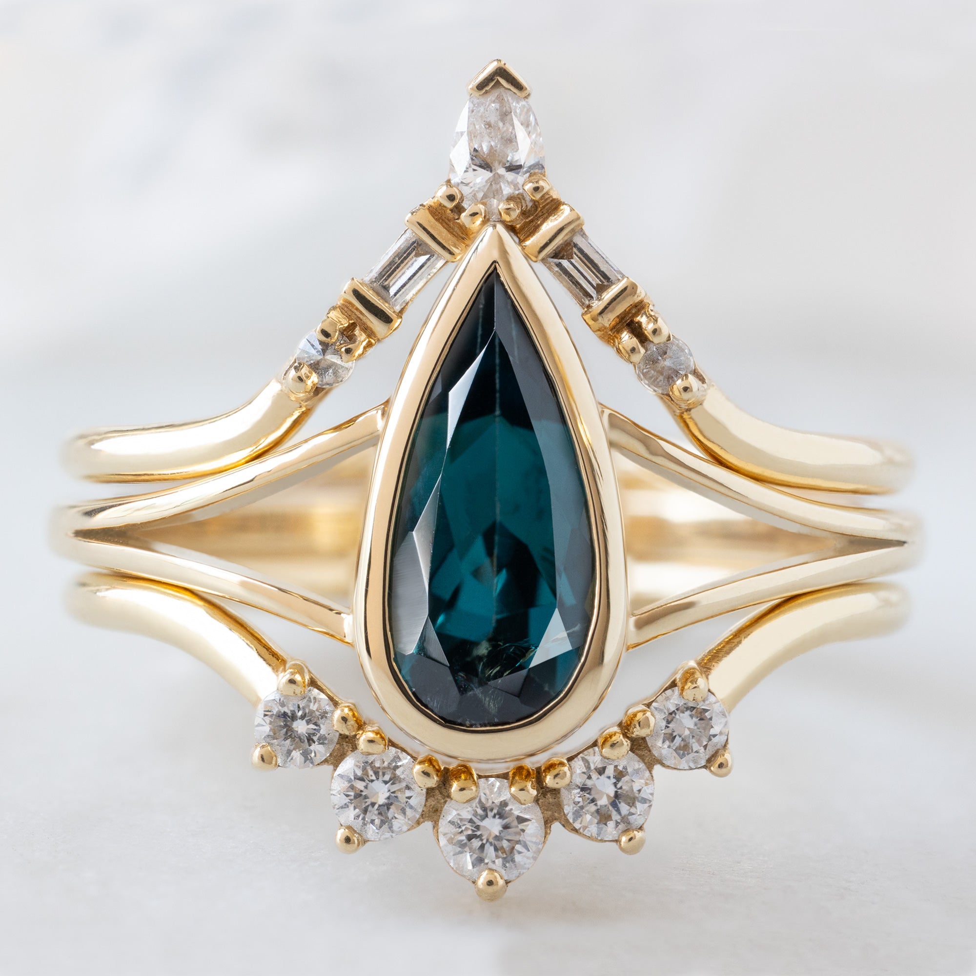 buy:white-diamond-tiara-stacking-band-14k-or-18k-yellow-gold,the-magnolia-ring-1-48ct-pear-blue-sapphire-in-14k-yellow-gold,round-white-diamond-sunburst-stacking-band-14k-or-18k-yellow-gold