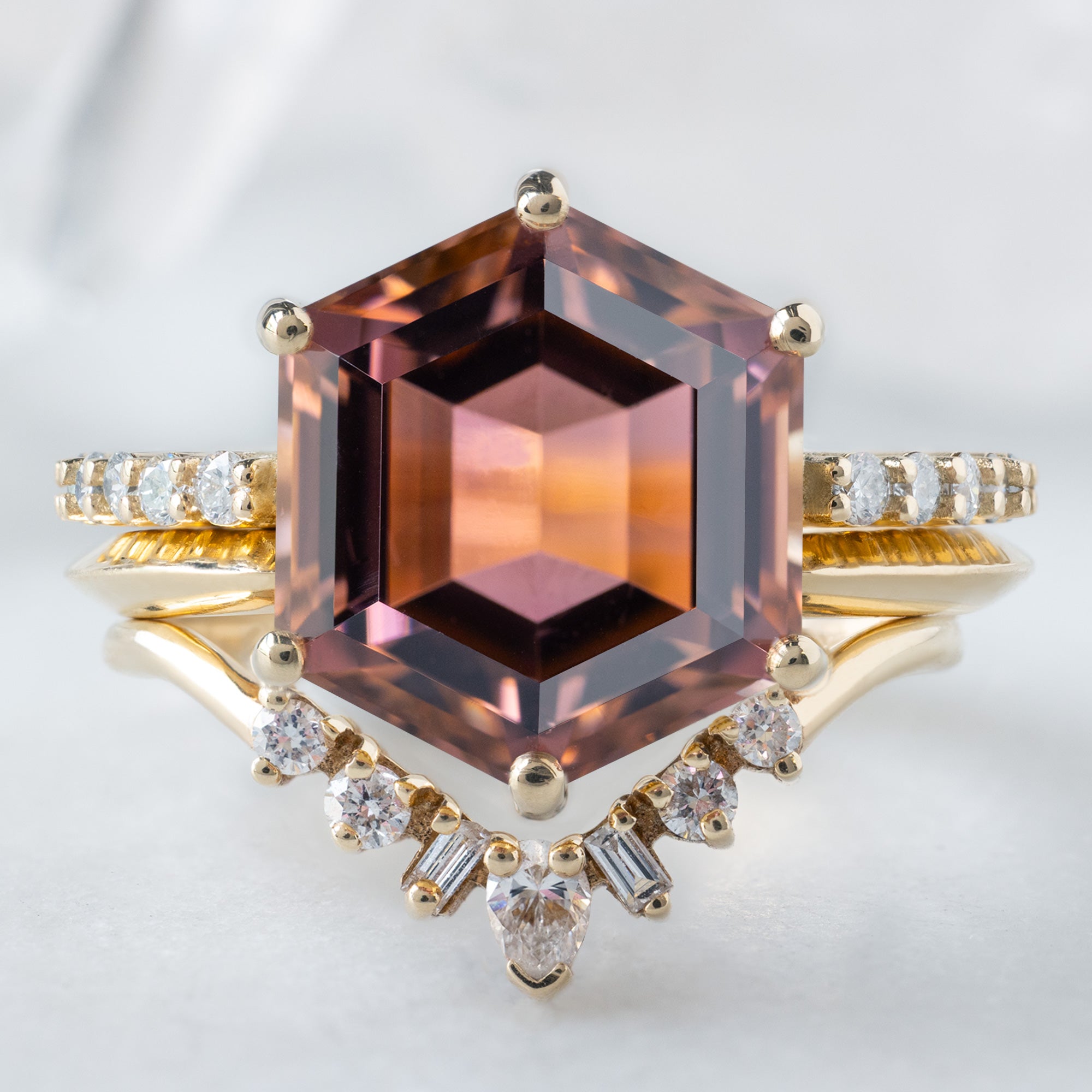 The Luxe Willow Ring with a 5.01ct Hexagon Tourmaline in 14K Yellow Gold stacked with the Open Cuff Knife Edge Stacking Band and Geometric Diamond Sunburst Stacking Band