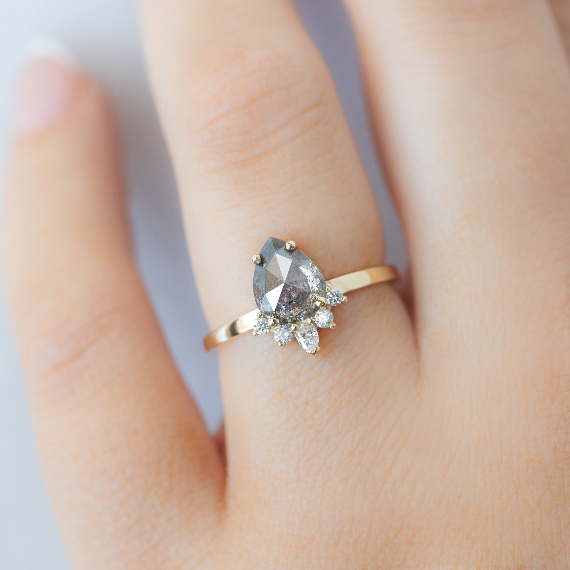 The Aster Ring with a 1.35ct Pear Salt and Pepper Diamond in 14K Yellow Gold on Model