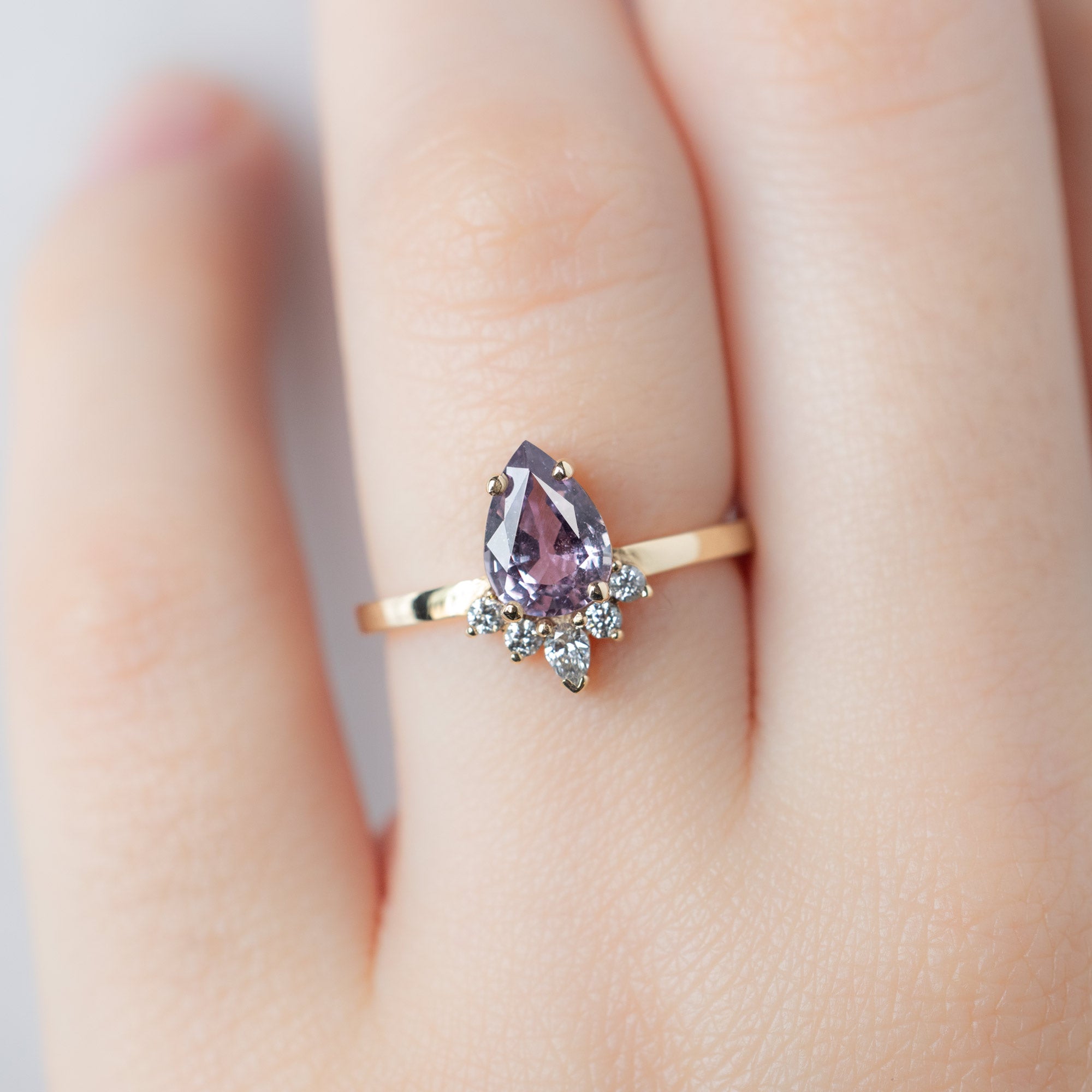 The Aster Ring with a 1.06ct Pear Purple Sapphire in 14K Yellow Gold on Model