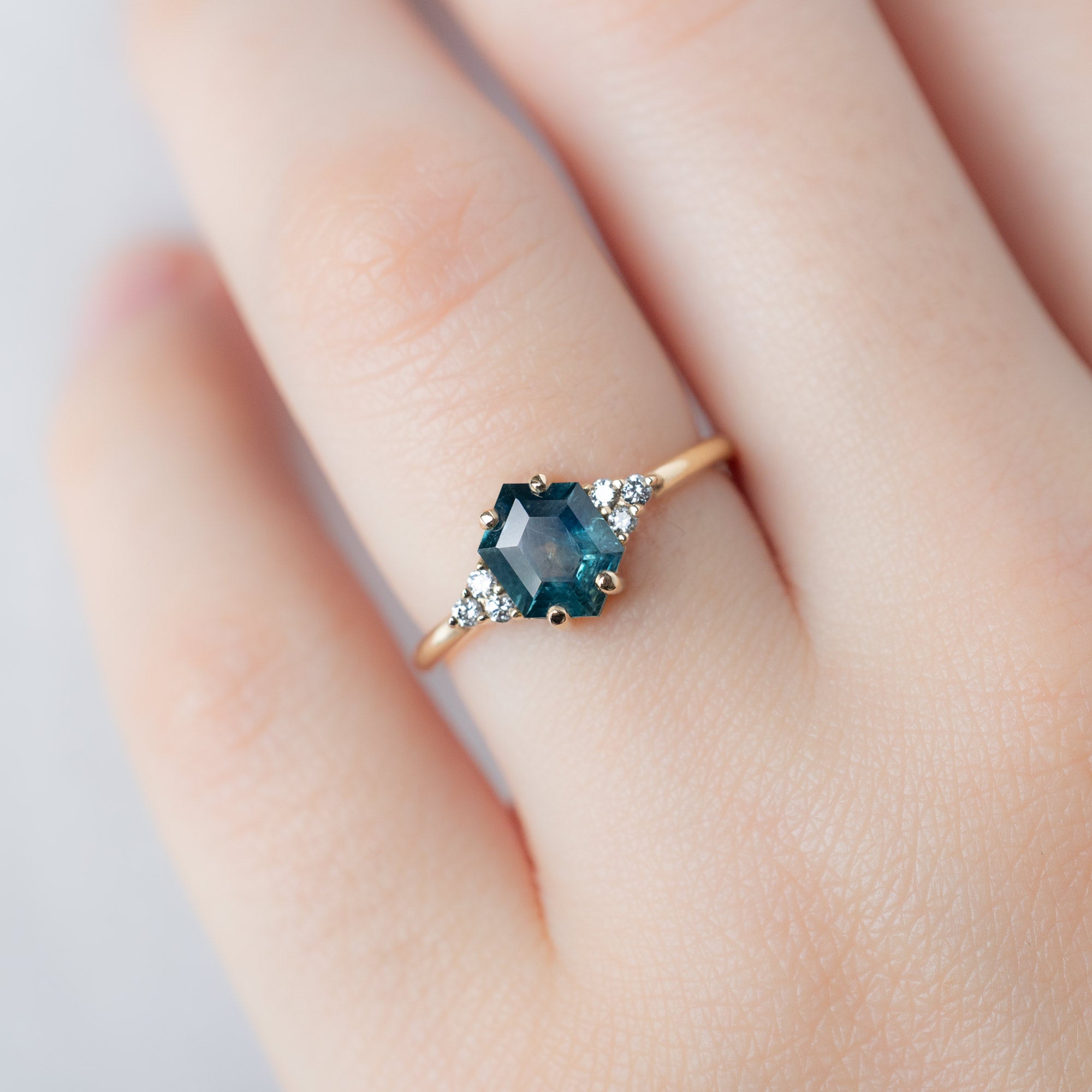 The Ivy Ring with a 1.22ct Hexagon Blue Sapphire in 14K Yellow Gold on Model