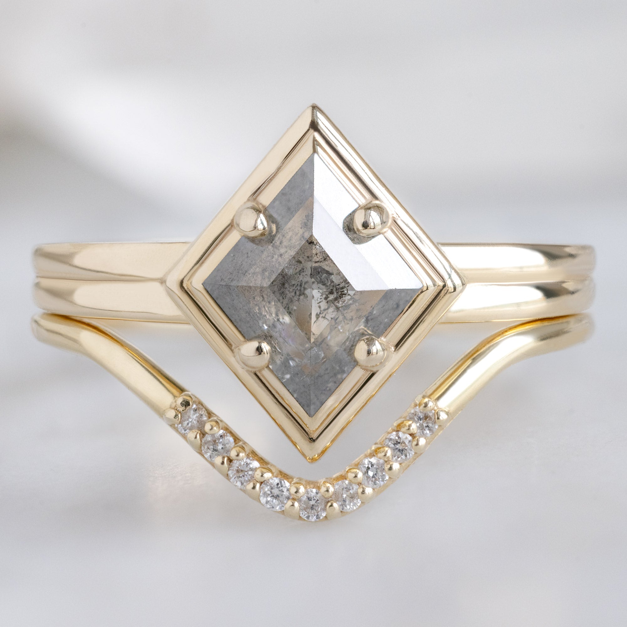 The Stratum Ring with a .65ct Kite Salt and Pepper Diamond in 14K Yellow Gold Stacked with the Salt and Pepper Pavé Diamond Stacking Band on White Background