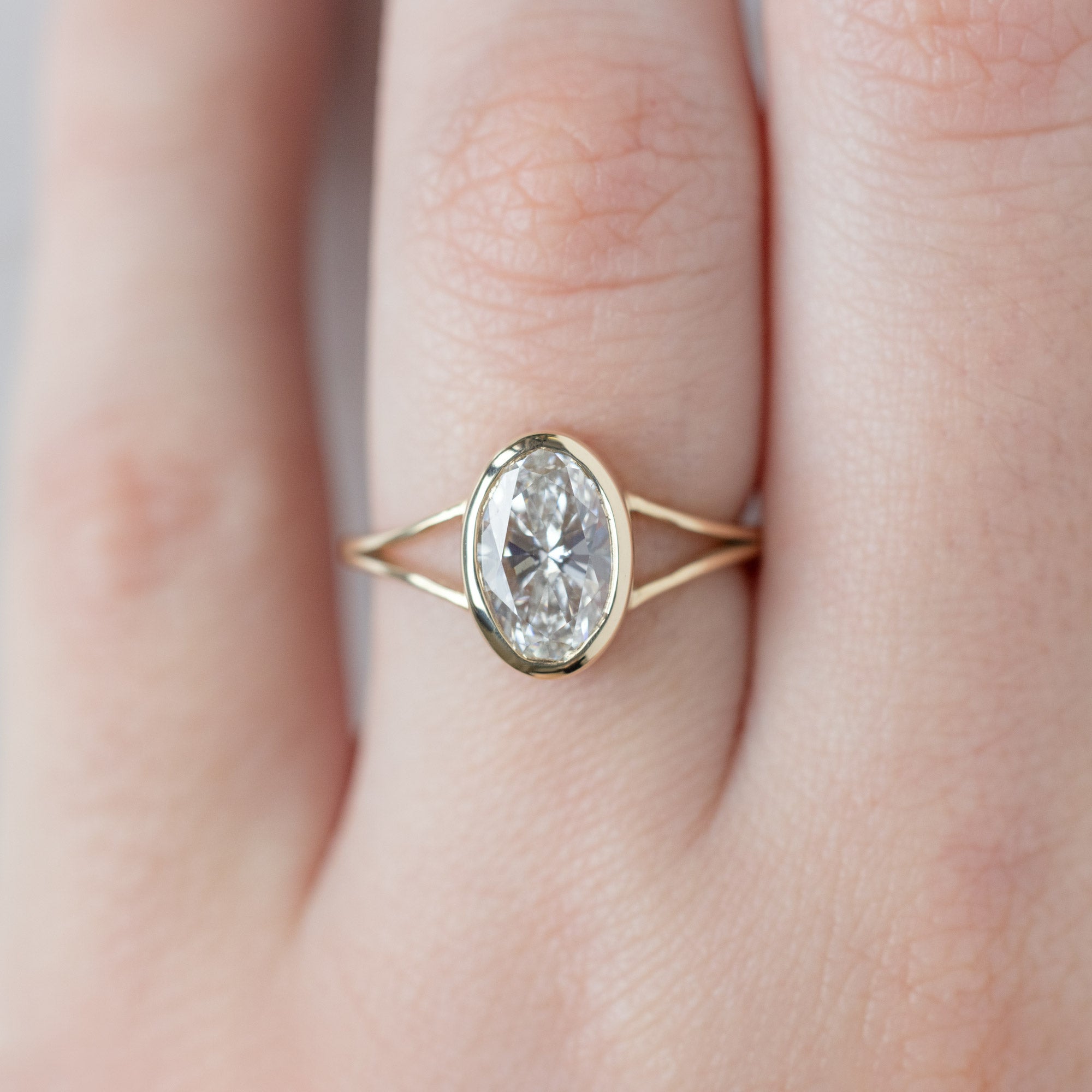 The Magnolia Ring with a 1.93ct Oval Lab Grown White Diamond in 14K Yellow Gold on Model