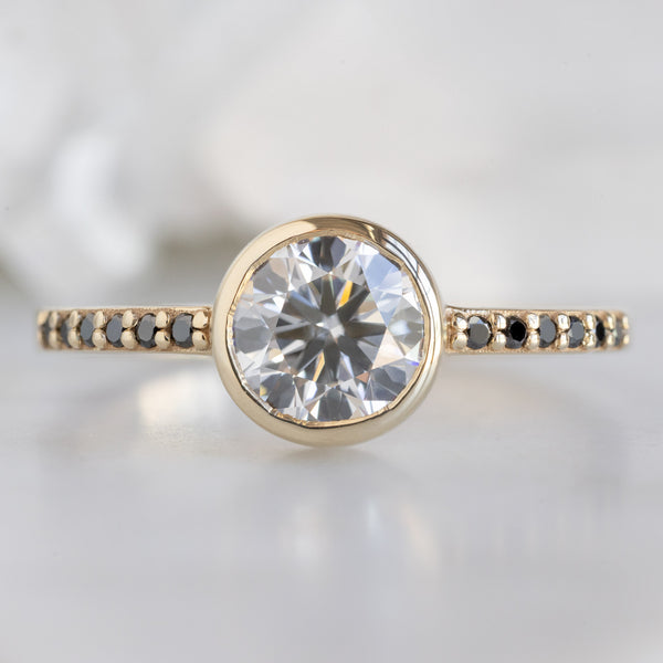 The Willow Ring with a 1.00ct Round Lab Grown White Diamond in 14K Yellow Gold on White Marble Surface