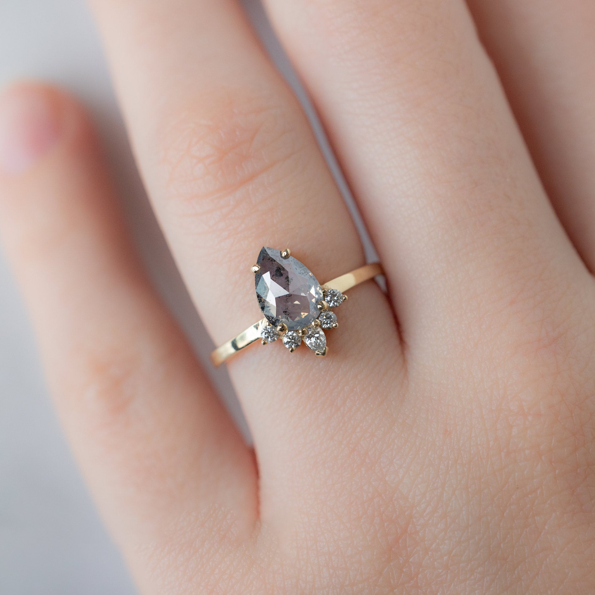 The Aster Ring with a 1.19ct Pear Salt and Pepper Diamond in 14K Yellow Gold on Model