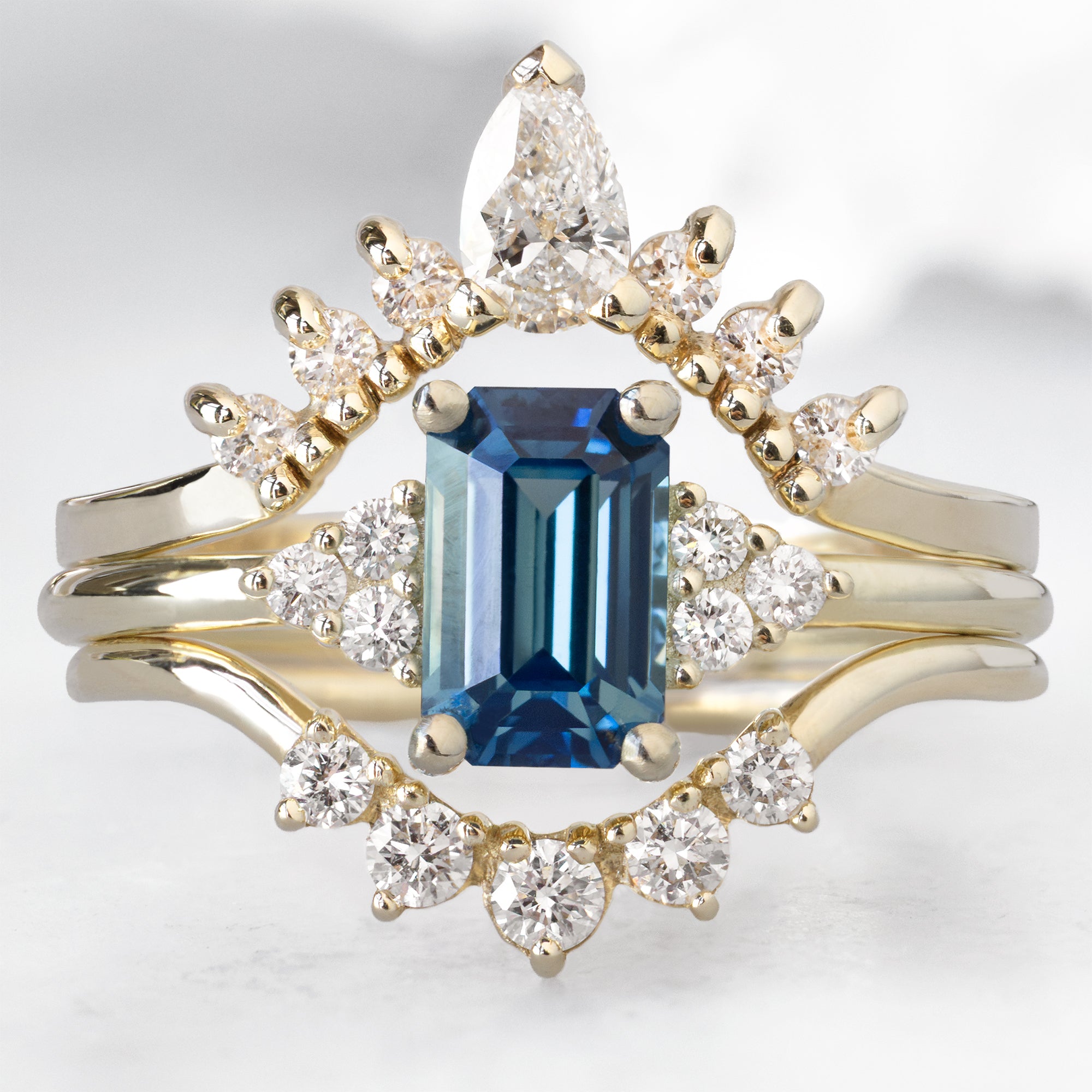 buy:white-pear-diamond-sunburst-stacking-band-14k-gold,the-ivy-ring-with-a-1-2ct-emerald-cut-blue-sapphire-in-14k-yellow-gold,round-white-diamond-sunburst-stacking-band-14k-or-18k-yellow-gold