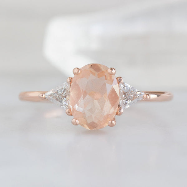 The Jade Ring with a 0.95ct Oval Sunstone in 14K Rose Gold on White Marble