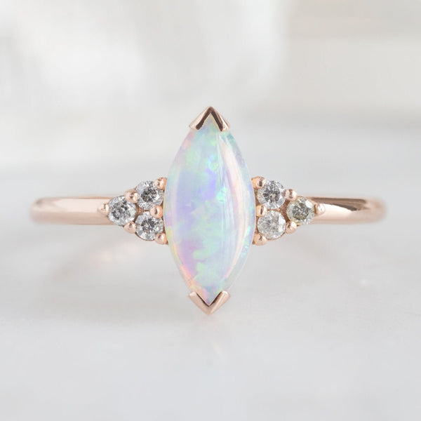 The Ivy Ring with a 0.37ct Marquise Opal in 14K Rose Gold on White Marble