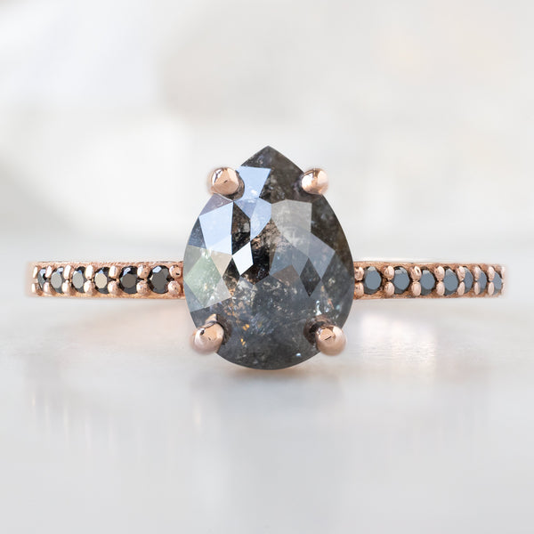 The Willow Ring with a 1.59ct Pear Black Diamond in 14K Rose Gold on White Marble