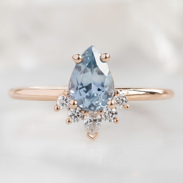 The Aster Ring with a Pear Blue Sapphire in 14k Rose Gold on White Marble