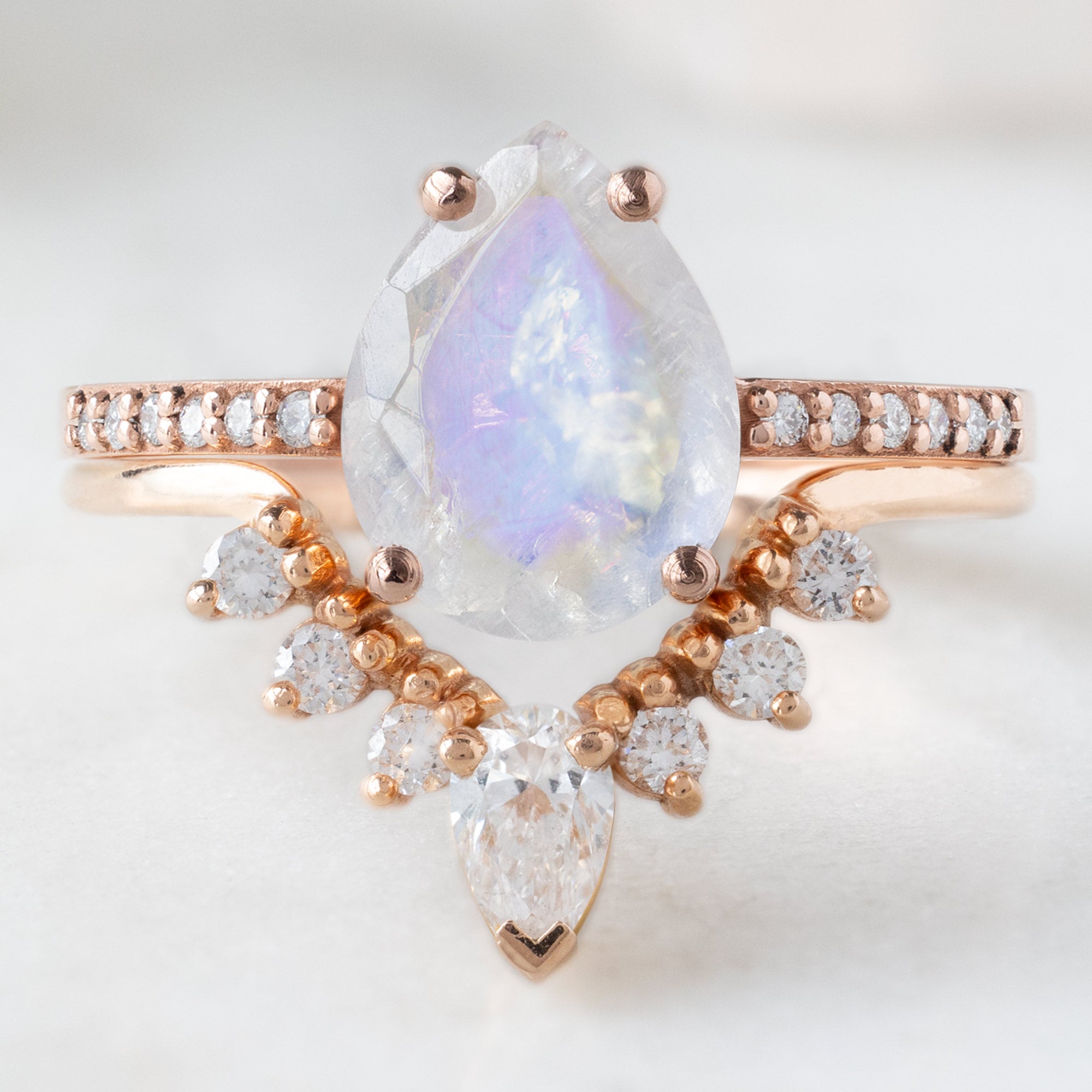 The Willow Ring with a 1.66ct Pear Moonstone in 14K Rose Gold stacked with the White Diamond Pear Sunburst Stacking Band