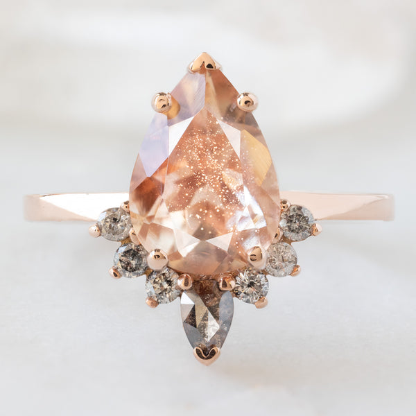 The Aster Ring with a 1.96ct Pear Sunstone in 14K Rose Gold on White Marble Surface