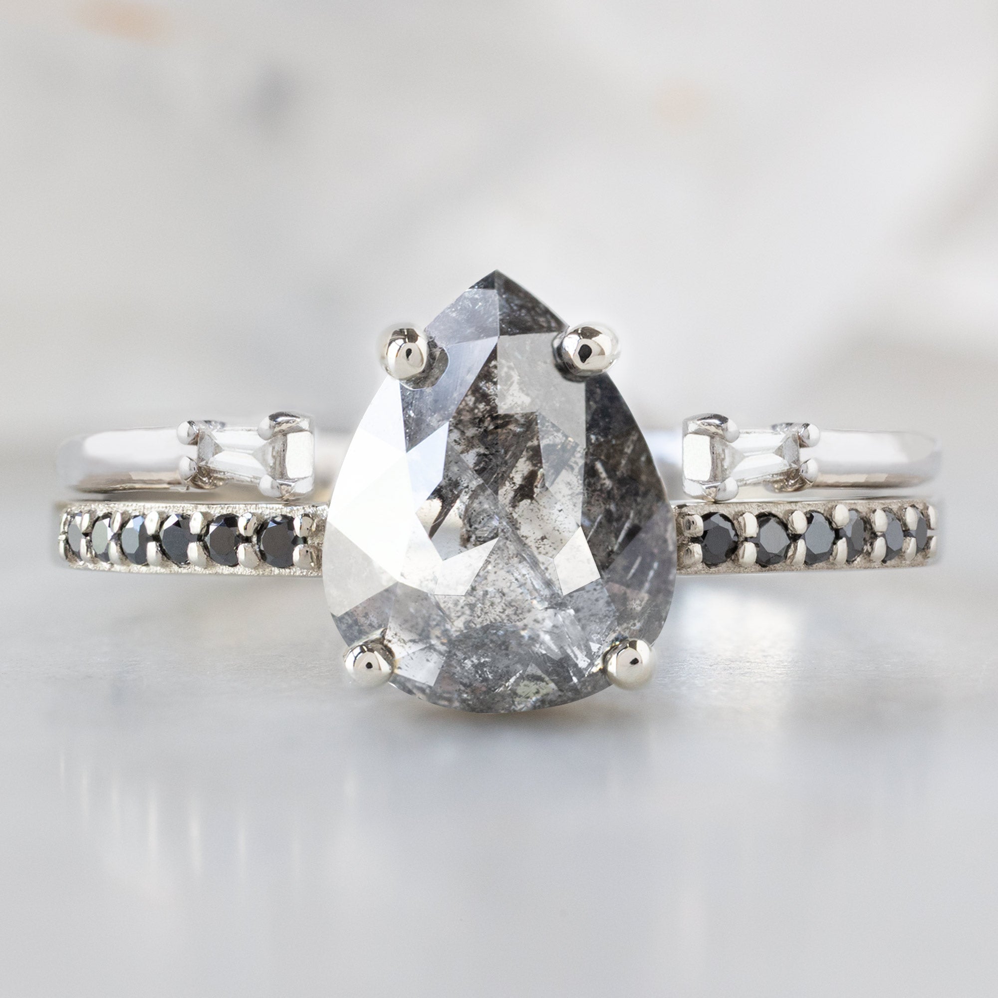The Willow Ring with a 1.54ct Pear Black Diamond in 14K White Gold Stacked with the Open Cuff Baguette Diamond Stacking Band