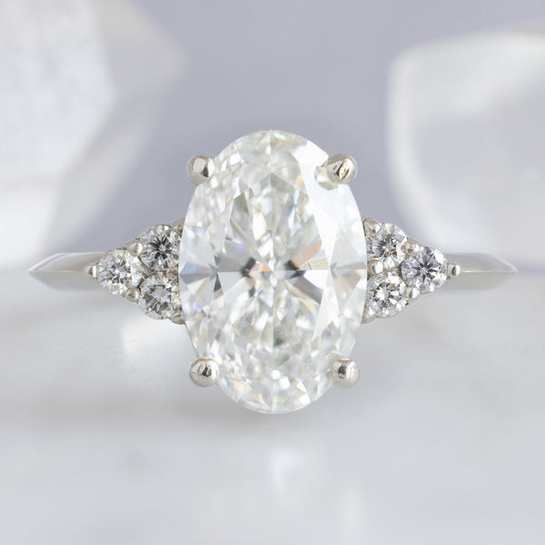 The Ivy Ring with a 1.88ct Oval Lab Grown White Diamond in 14K White Gold on light grey background