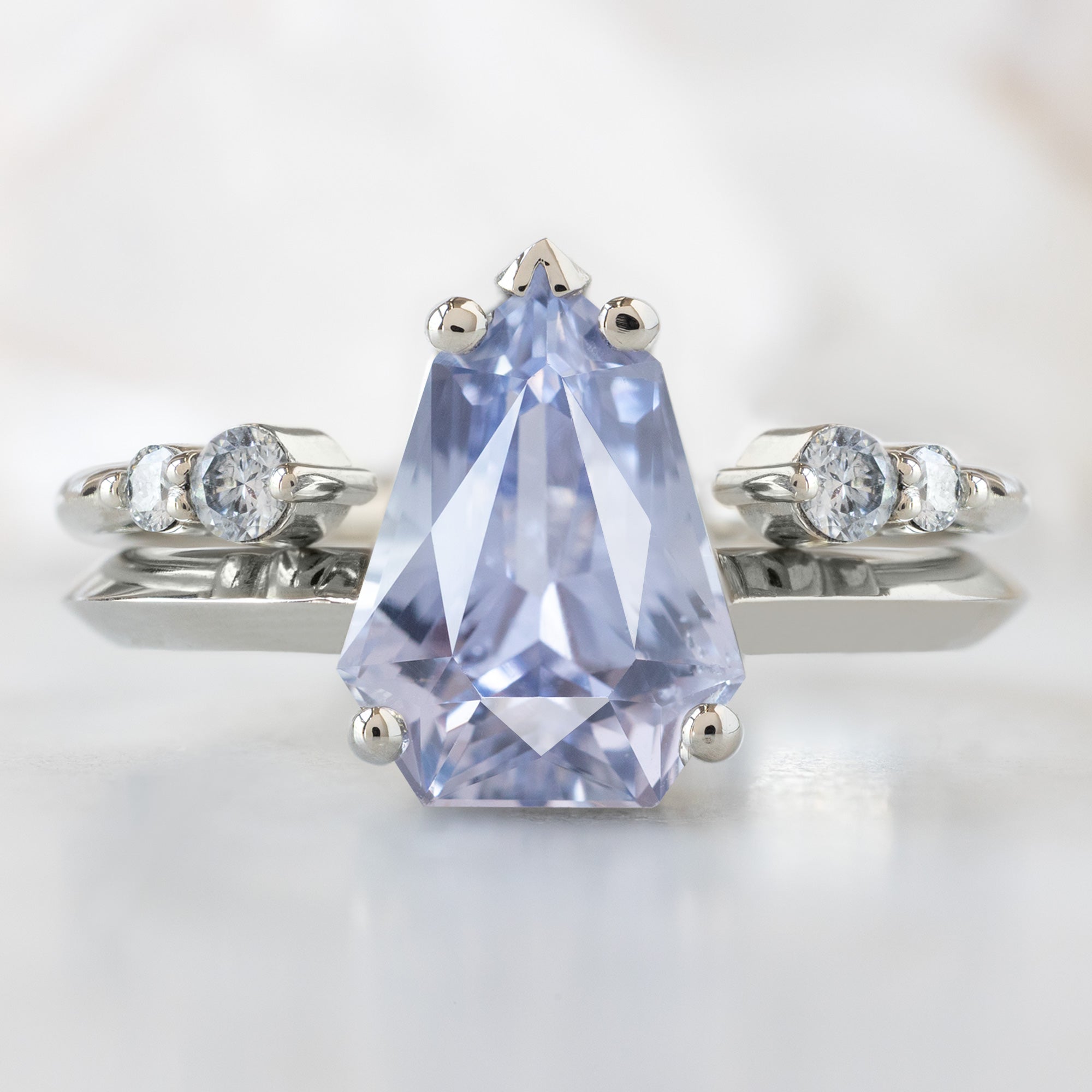 The Sage Ring with a 2.33ct Geometric Periwinkle Sapphire in 14K White Gold Stacked with the Open Cuff Luxe White Diamond Stacking Band