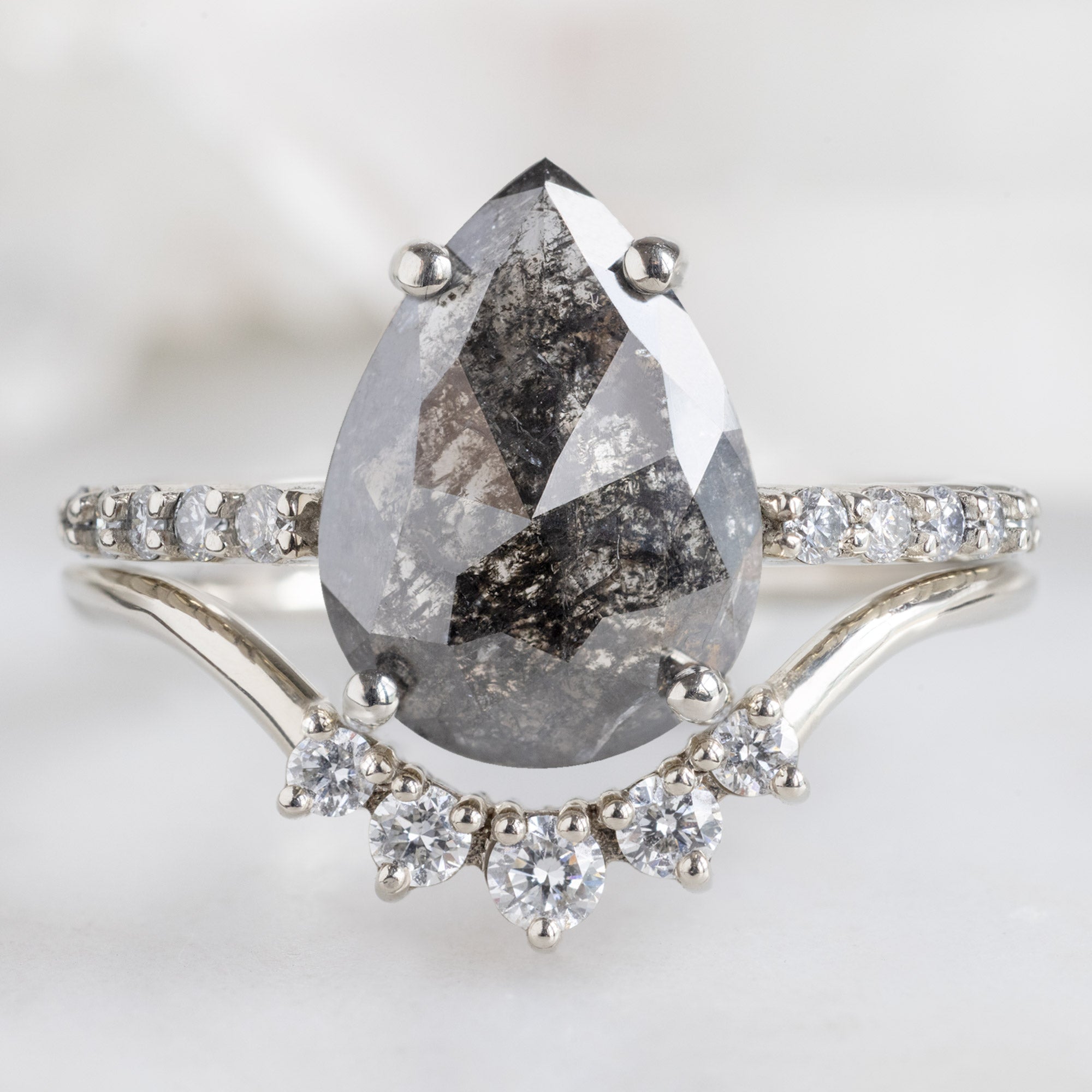 The Luxe Willow Ring with a 2.03ct Pear Black Diamond in 14K White Gold Stacked with the Round White Diamond Sunburst Stacking Band
