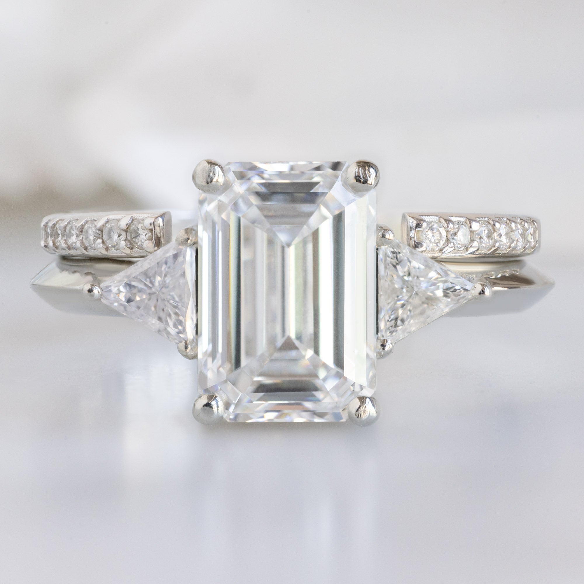 The Jade Ring with a 2.00ct Emerald Lab Grown White Diamond in 14K White Gold Stacked with the Open Cuff White Diamond Pavé Stacking Band on White Marble Surface