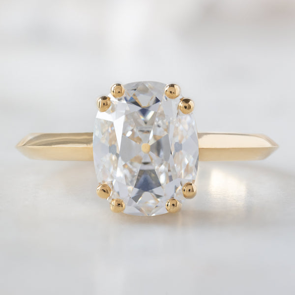The Bryn Ring with a 2.05ct Old Mine Cut Lab Grown Diamond in 18K Yellow Gold on White Marble