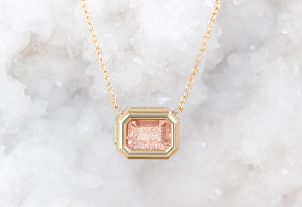 Emerald-Cut Sunstone Necklace hanging on white crystal