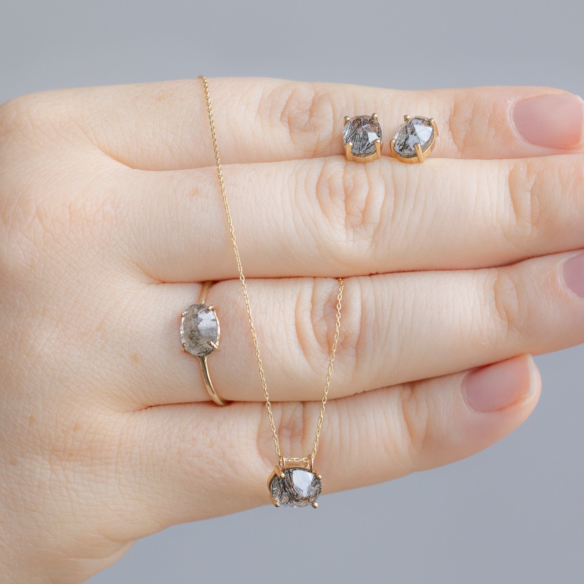 Model holding the The Tourmaline in Quartz Set in Yellow Gold