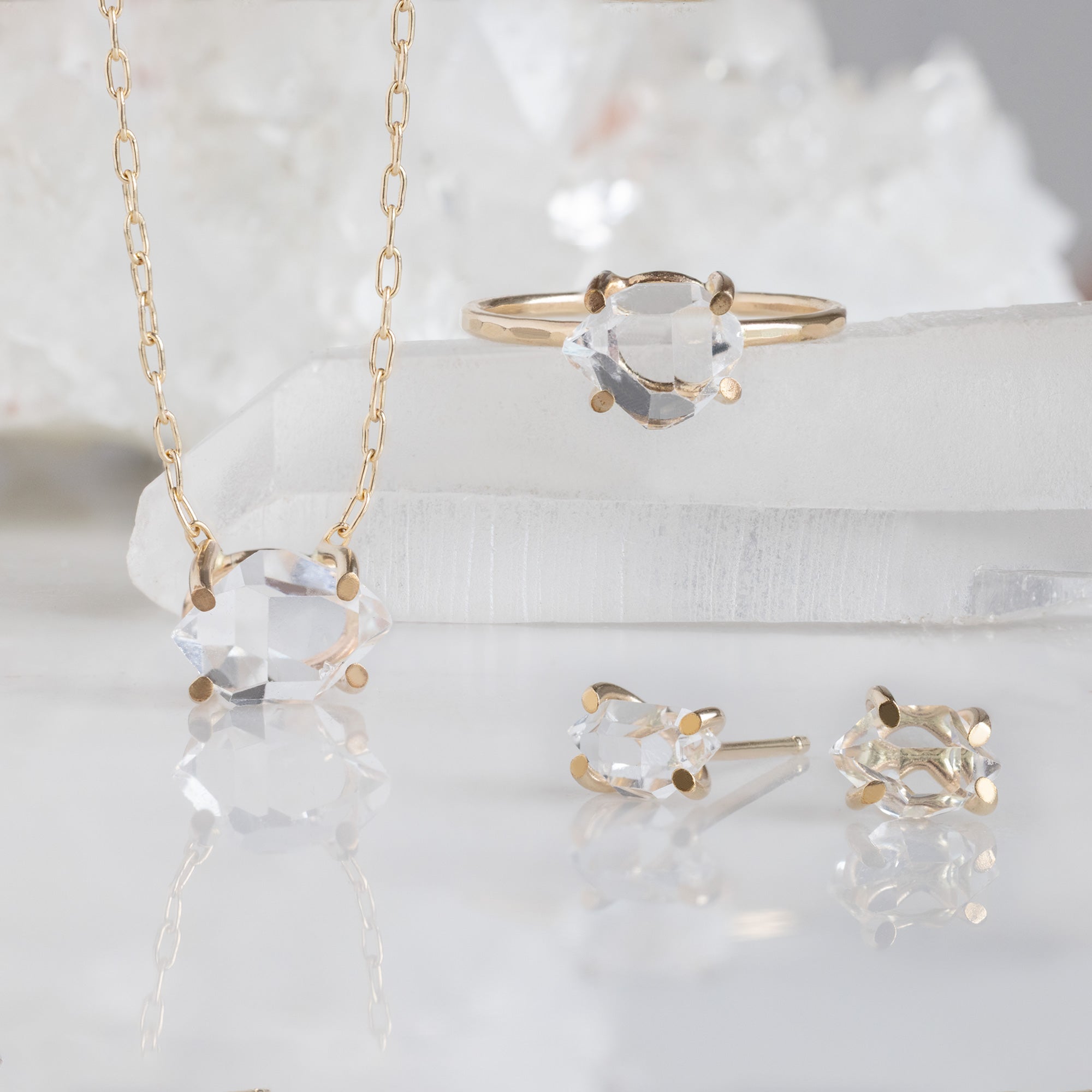 The Herkimer Diamond Set in Yellow Gold on White Marble Surface