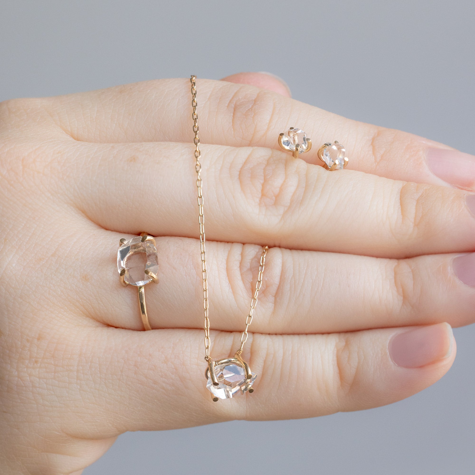 Model Holding the The Herkimer Diamond Set in Yellow Gold