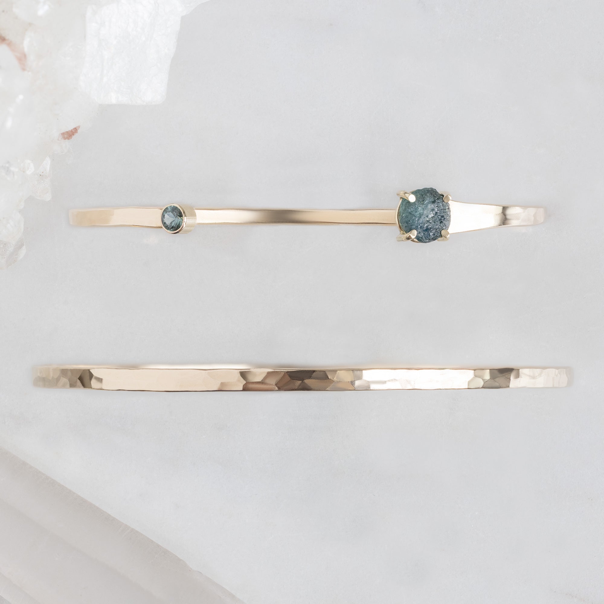 The Sapphire Cuff Set on White Marble Surface