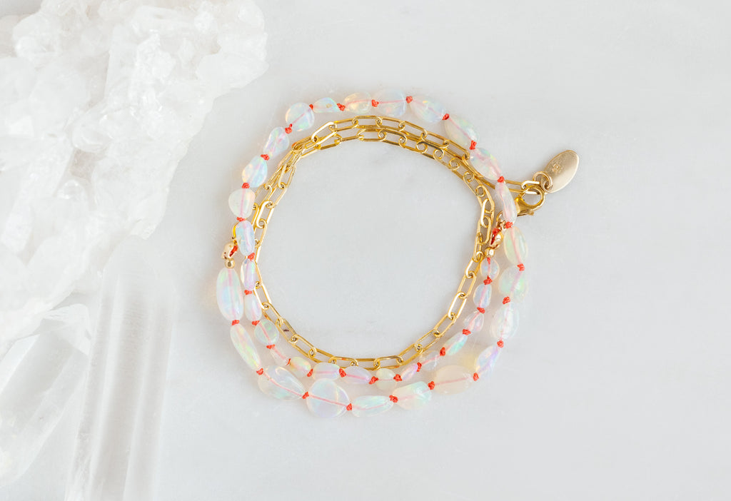 Knotted Opal Bracelet on White Marble Tile