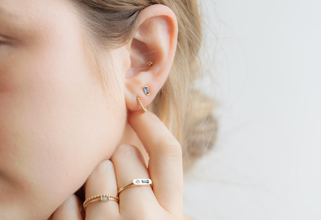 Montana Sapphire Baguette Studs on Model with Hand Touching Ear