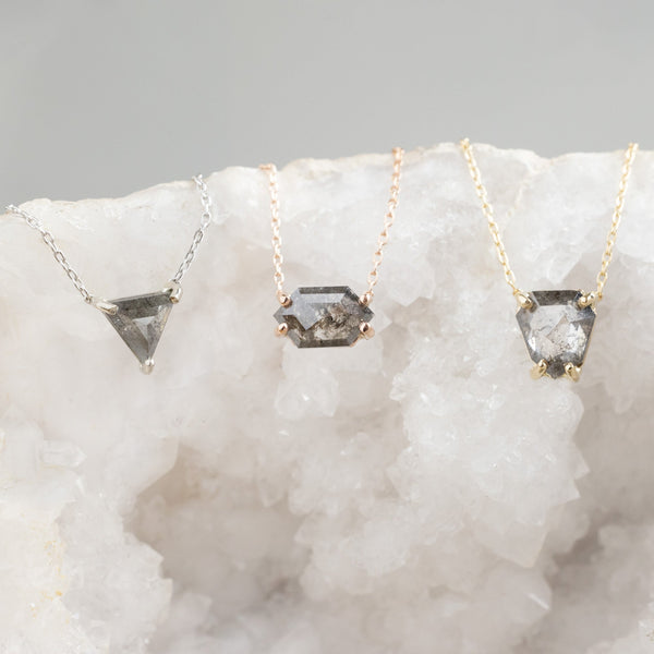 One of a Kind Diamond Necklaces in Yellow, Rose and White Gold laying on white crystal