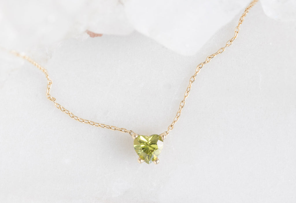 Yellow Gold Sweetheart Peridot Necklace in White Marble Tile