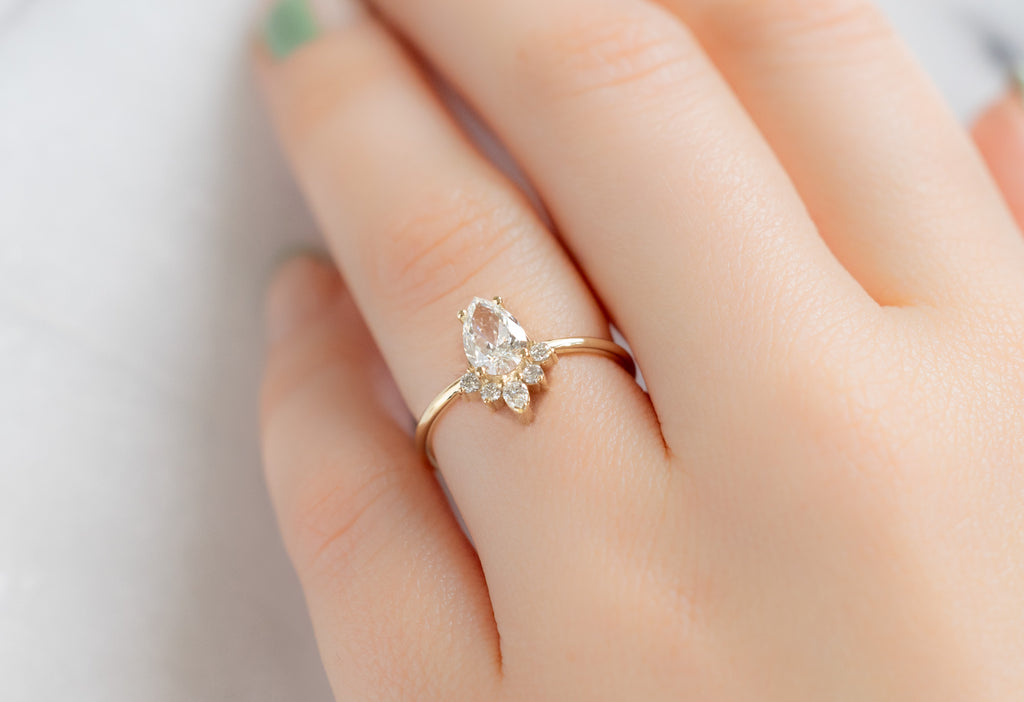 The Aster Ring with a Pear-Cut White Diamond on Model