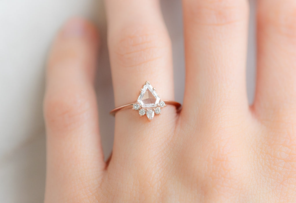 The Aster Ring with a Shield-Cut White Diamond on Model