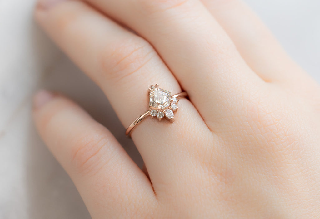 The Aster Ring with a Shield-Cut White Diamond on Model