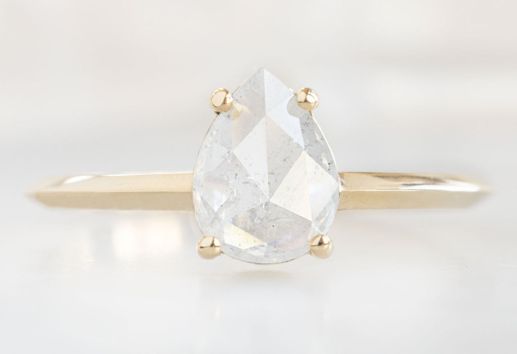 The Bryn Ring with a Rose-Cut Icy White Diamond on White Marble Tile