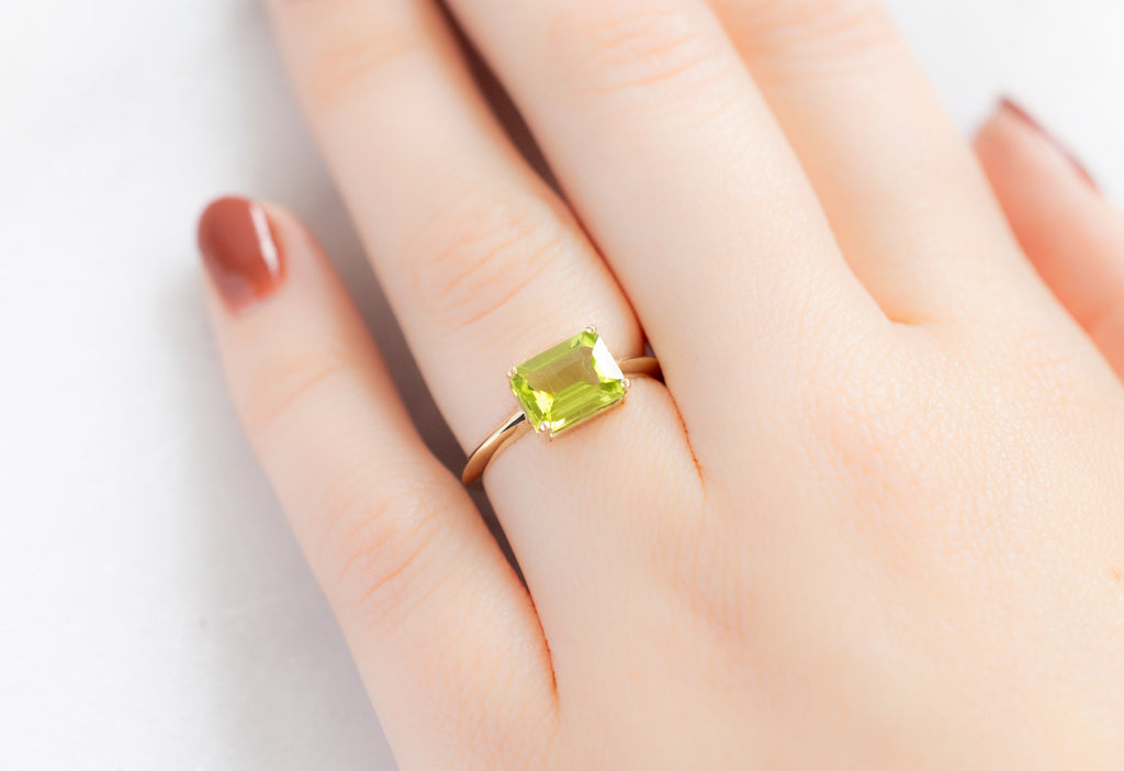 The Bryn Ring with an Emerald-Cut Peridot on Model