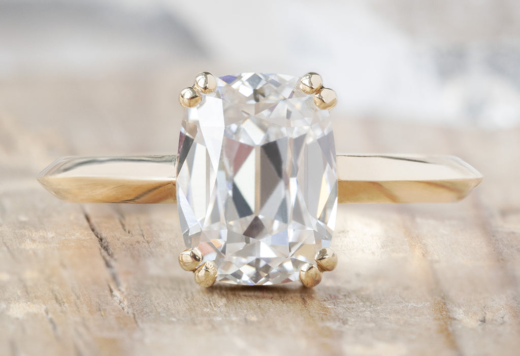 The Bryn Ring with an Old Mine Cut Lab Grown Diamond on Wood Table