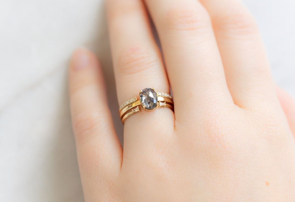 The Bryn Ring with an Oval-Cut Salt and Pepper Diamond with Open Cuff Stacking Bands on Model