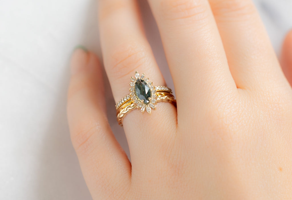 The Camellia Ring with a Marquise Sapphire with Stacking Bands on Model