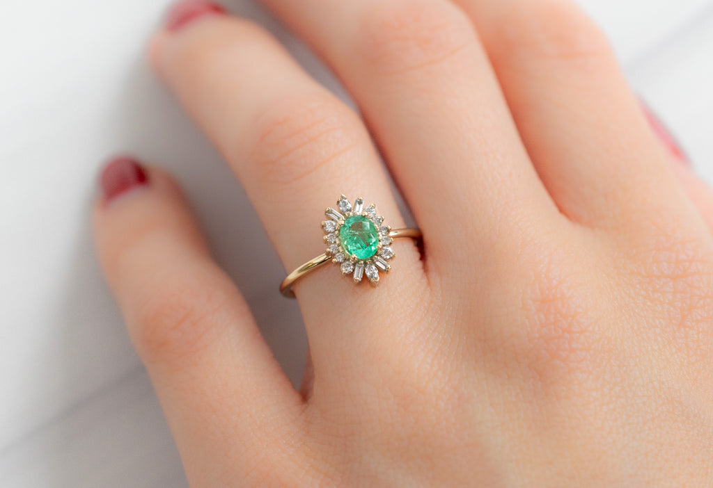 The Camellia Ring with an Oval-Cut Emerald on Model