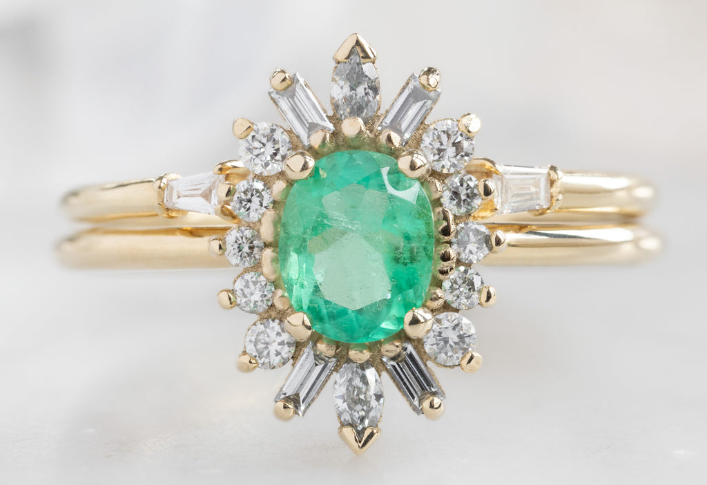 The Camellia Ring with an Oval-Cut Emerald with Open Cuff Diamond Baguette Stacking Band