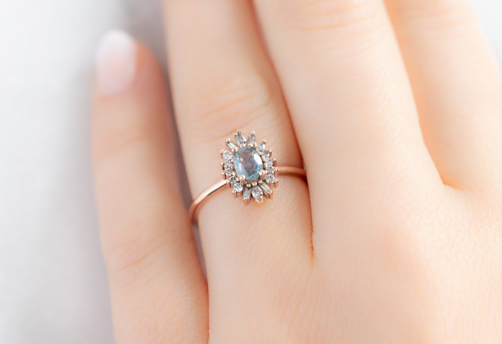 The Camellia Ring with an Oval-Cut Montana Sapphire on Model