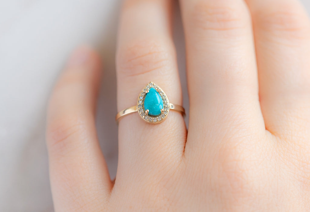 The Dahlia Ring with a Sleeping Beauty Turquoise on Model
