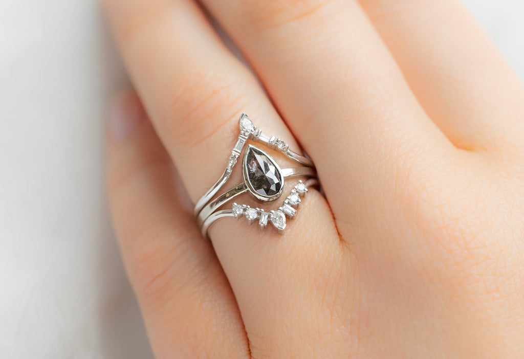 The Hazel Ring with a Rose-Cut Black Diamond with White Diamond Stacking Bands on Model