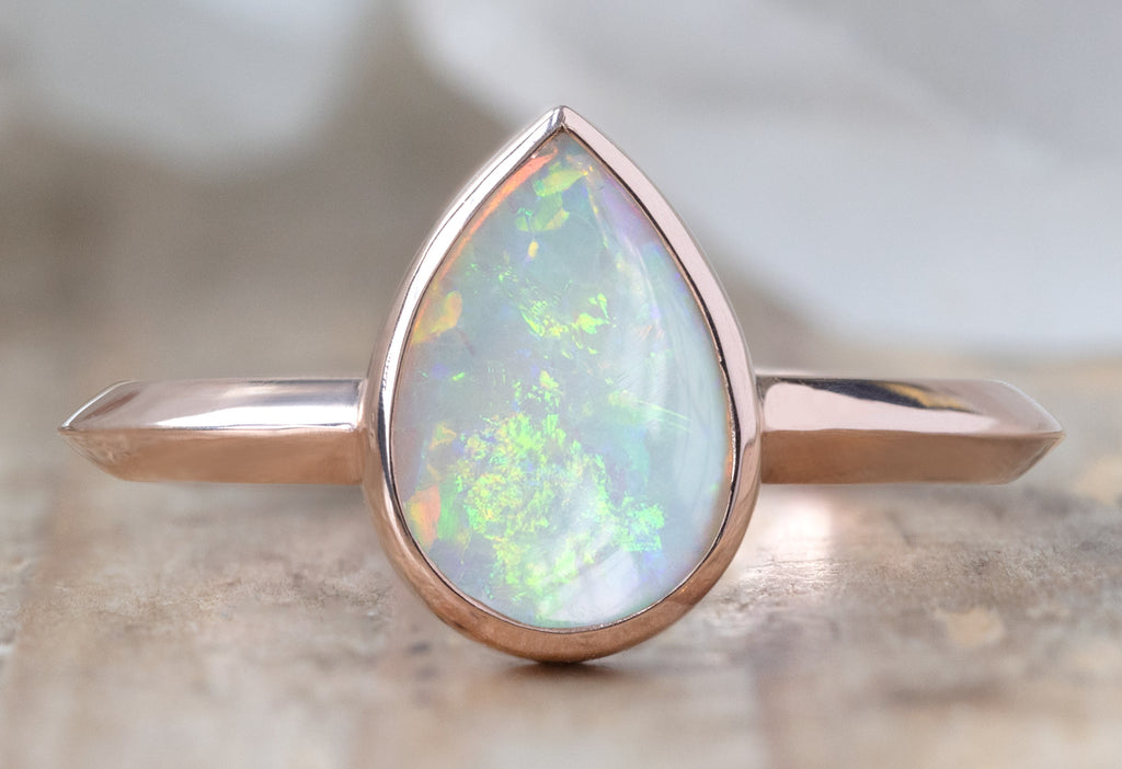 The Hazel Ring with an Australian Opal on Wood Table
