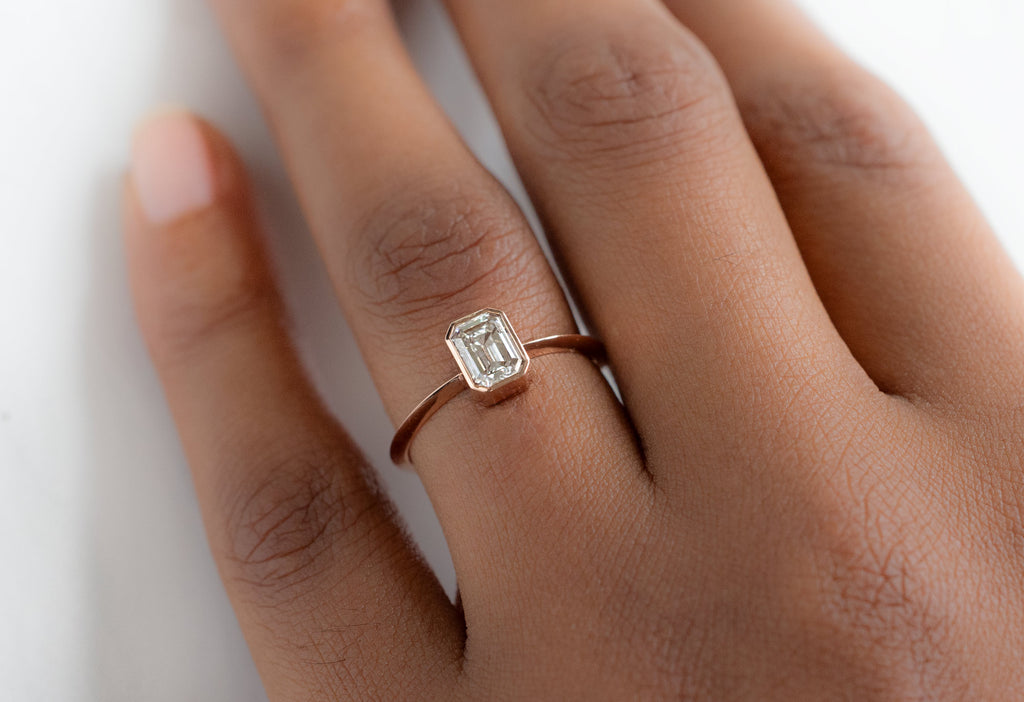 The Hazel Ring with an Emerald-Cut White Diamond on Model