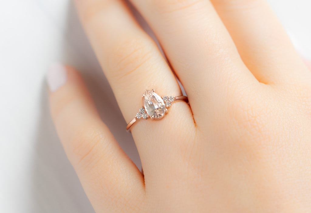 The Ivy Ring with a Pear-Cut Peach Sapphire on Model