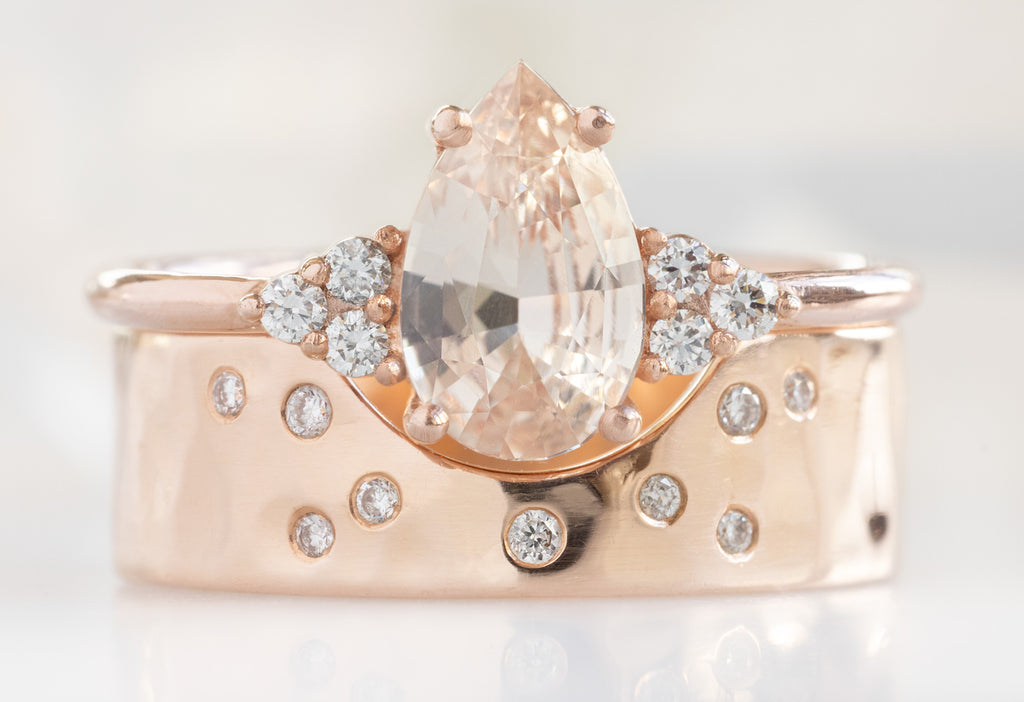 The Ivy Ring with a Pear-Cut Peach Sapphire with Constellation Cut-Out Stacking Band