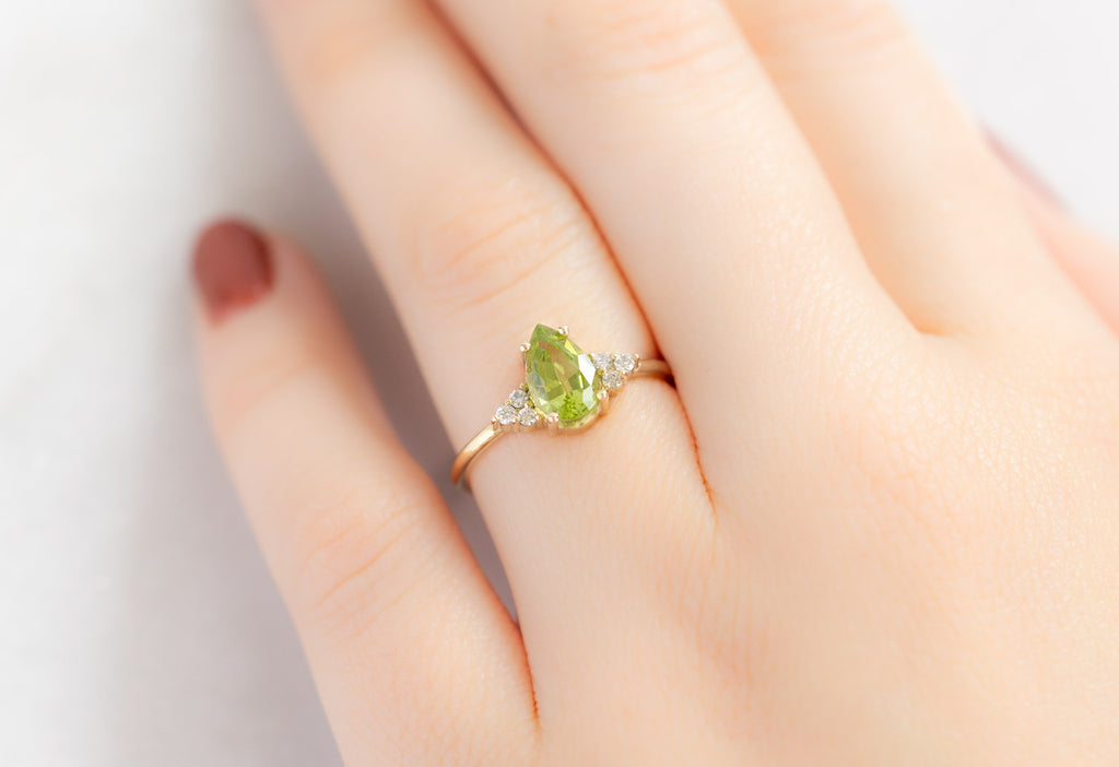 The Ivy Ring with a Pear-Cut Peridot on Model