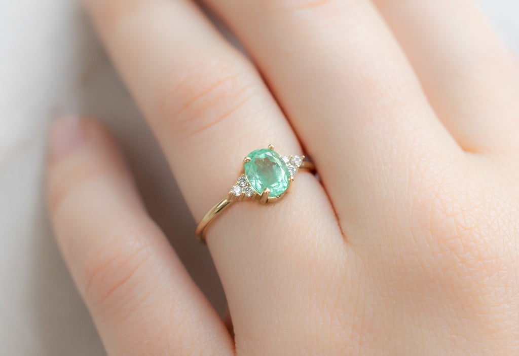 The Ivy Ring with an Oval-Cut Emerald on Model